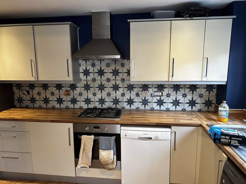 Kitchen in Exmouth with a blue and white patterned star-tile splashback